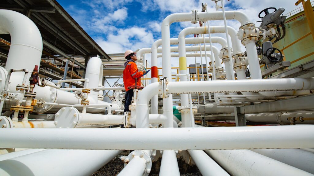 A male worker inspects steel pipes