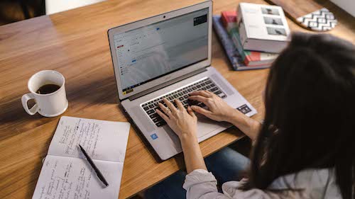 Photo of a salesperson working on a laptop to target the right customers for the sales pipeline.